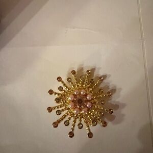 Gold and Pink Starburst Brooch with Radiant Design
Bundle items to save shipping
